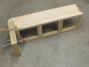 Bonded breaker-switch box assembly to passenger side overhead cabinet