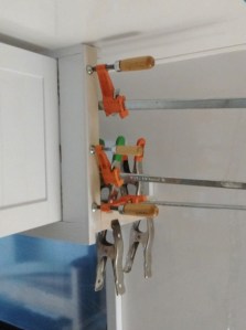 Bonded spacers to upper kitchen cabinet