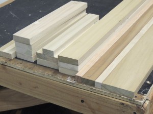 Cut lumber for bed headboard and passenger side upper cabinet