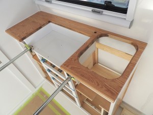 Dry fit, masked, prepped, bonded, screwed, and installed lower kitchen cabinet