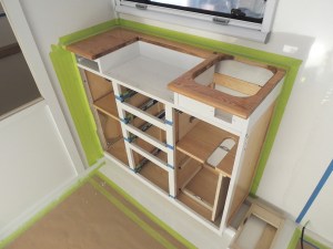 Dry fit, masked, prepped, bonded, screwed, and installed lower kitchen cabinet