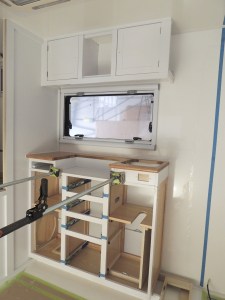 Dry fit, masked, prepped, bonded, screwed, and installed lower kitchen cabinet