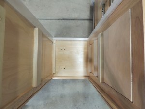 Fabricated and installed shelves, mounting plates, and support spacers inside kitchen cabinet