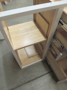 Fabricated and installed shelves, mounting plates, and support spacers inside kitchen cabinet