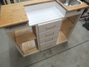 Fabricated and installed shelves, mounting plates, and support spacers inside kitchen cabinet