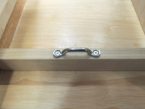 Installed footman's loops for securing cabinet contents