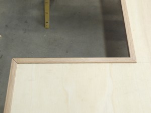 Bonded oak trim to shower area divider