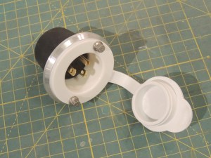 Machined mounting plate for ground power plug