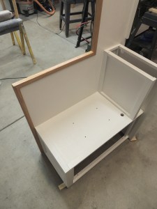 Masked and urethaned red oak edge trim on shower area divider