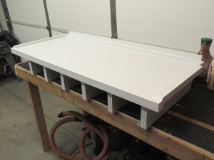 Appied final coat of paint to headboard-cubby assembly