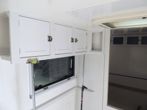 Fit checked, prepped, bonded, and screwed passenger overhead cabinet