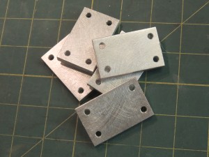 Machined spacers for cabinet door latches