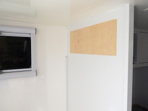 Prepped, bonded, and screwed overbed cabinets on rear bed walls