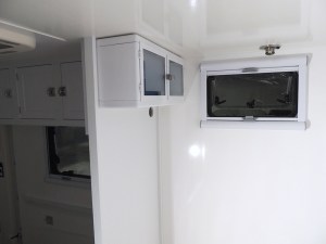 Prepped, bonded, and screwed overbed cabinets on rear bed walls