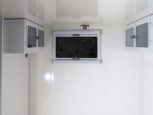 Prepped, bonded, and screwed overbed cabinets on rear bed walls