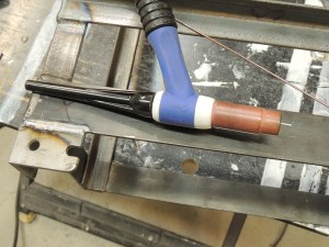 Welded lock plates to under subframe storage box mounts