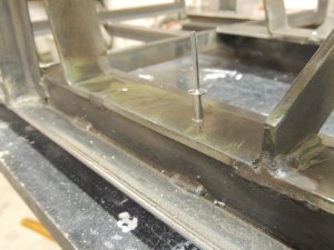 Enlarged rivet holes for jerry can bumpers on under subframe storage box mount