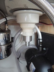 Installed sink drain and connected to drain hose