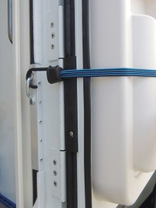 Installed entry door hold open catch bracket and footman's loop